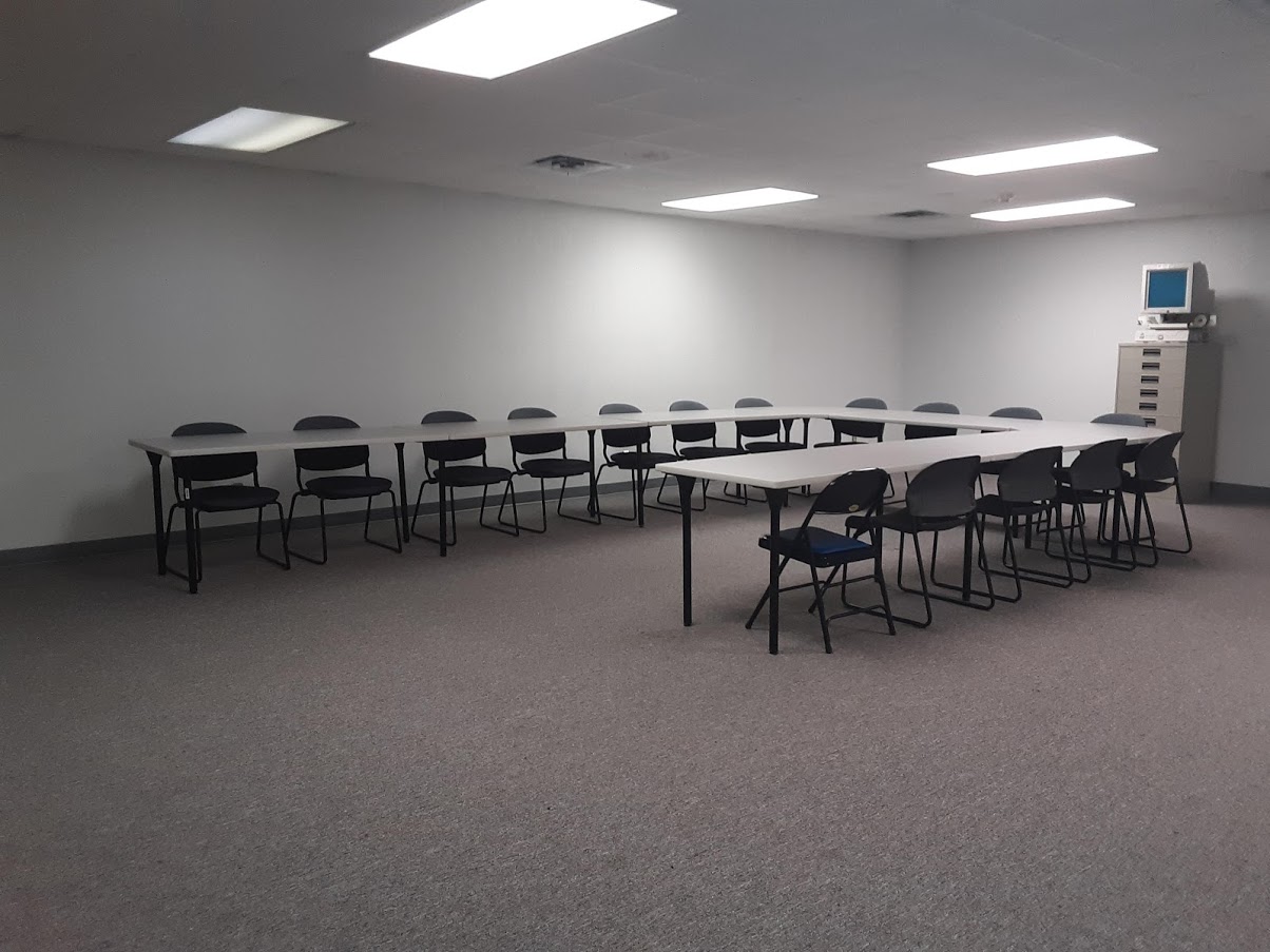 Image of U-shaped table surrounded by chairs.