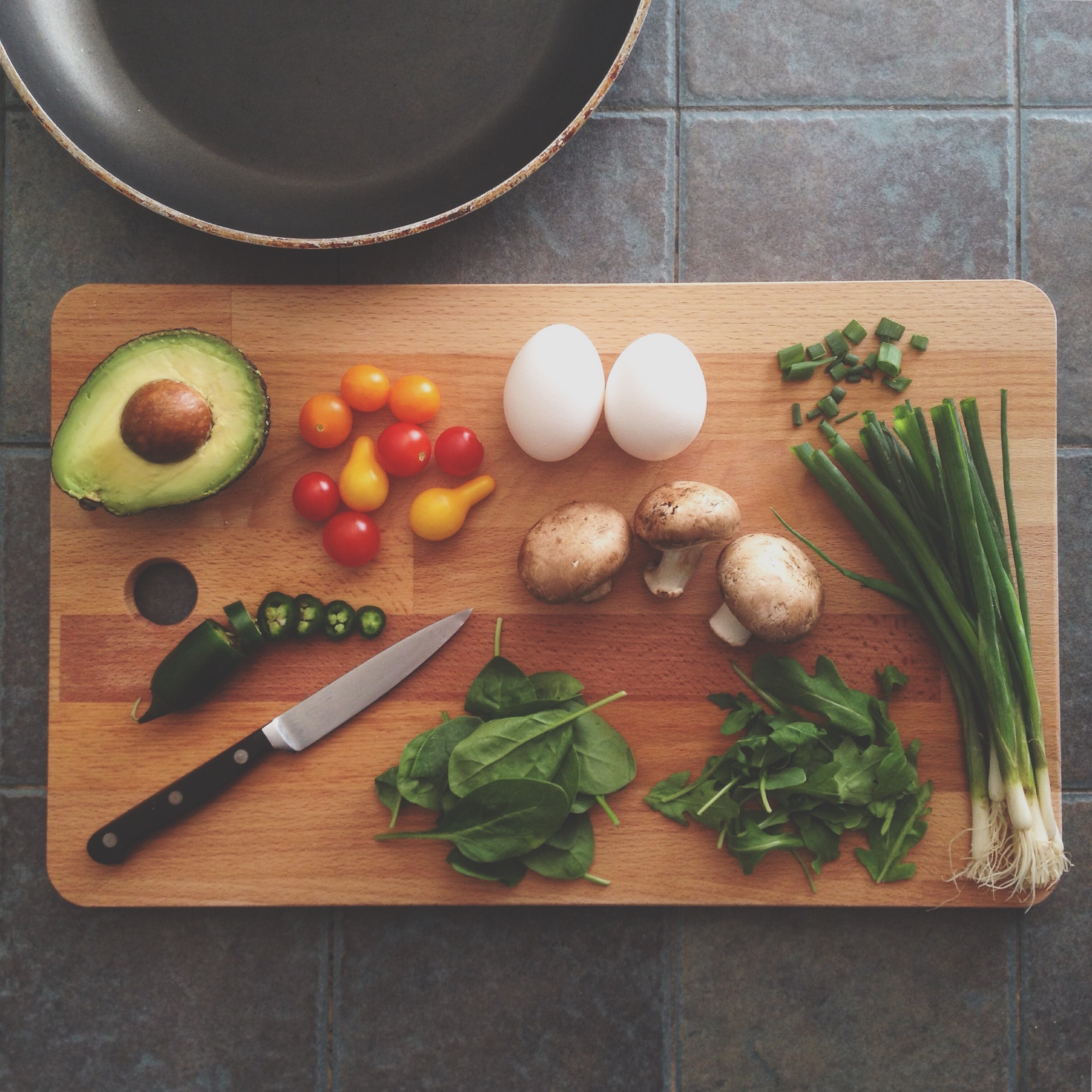 Cutting board with an array of sliced vegetables.