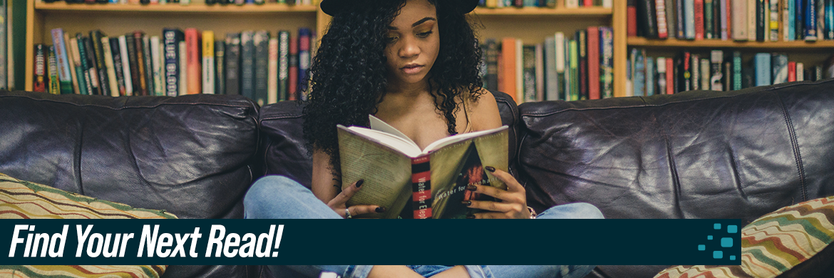 Girl sitting on couch and reading a book