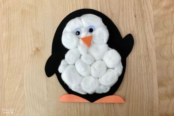 A craft penguin made using construction paper and cotton balls. 