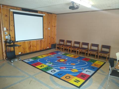 Photo of meeting room with a projector screen.